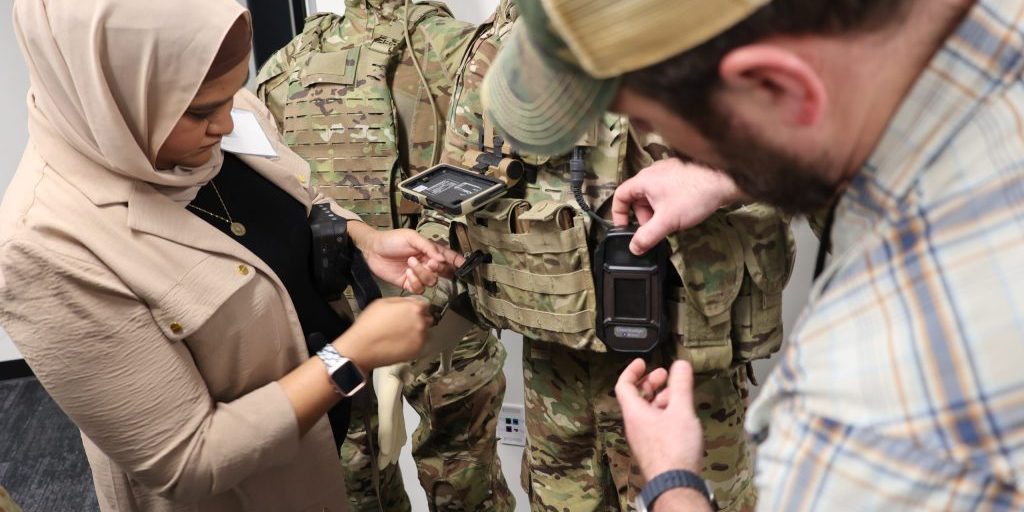 230503-A-KY597-508 Staff fit a mannequin with a compact vapor chemical agent detector (CVCAD) prototype to test how a future Soldier may wear the CBRN sensor as part of their future kit (JPEO-CBRND)