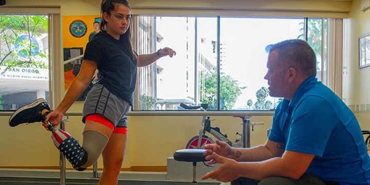 U.S. Marine LCpl. Annika Hutsler works with James Malinak, a prosthetician at the Naval Medical Center San Diego’s Comprehensive Combat and Complex Casualty Care clinic to adjust her prosthetic leg. C5 serves to deliver multidisciplinary, quality health services in an outpatient rehabilitation facility for wounded, ill, and injured service members (photo:  U.S. Navy Mass Communication Specialist 3rd Class Jake Greenberg).