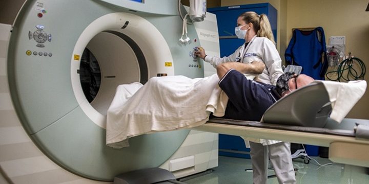 Michelle Pribble, Naval Medical Center San Diego's lead nuclear medicine technologist, prepares a patient for a positron emission tomography (PET) scan in the hospital's Nuclear Medicine Department on October 6. A PET scan is used for revealing or evaluating conditions, including brain disorders (photo by Navy Mass Communication Specialist Seaman Luke Cunningham).