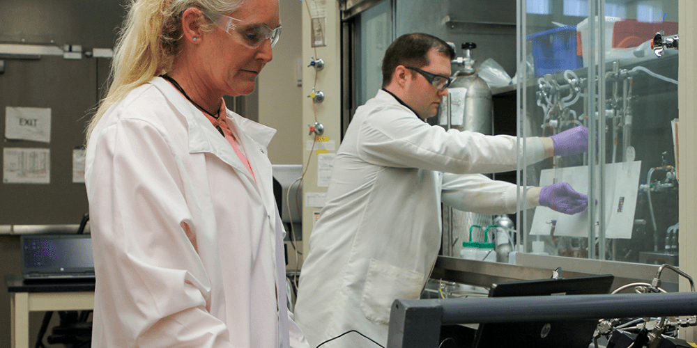 Two scientists performing an experiment in a laboratory.